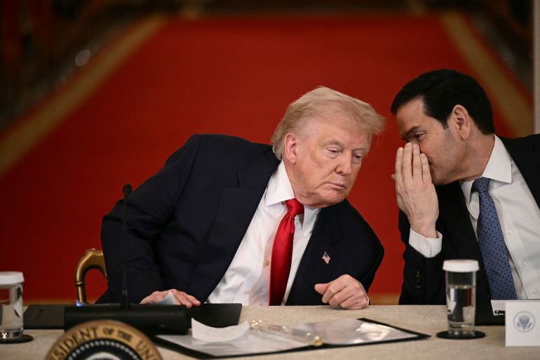 US President Donald Trump and Secretary of State Marco Rubio speak during a roundtable to "save college sports" in the East Room of the White House in Washington, DC, on March 6, 2026. (Photo by Brendan SMIALOWSKI / AFP)