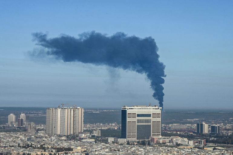 Smoke billows from an oil warehouse in the Kani Qirzhala area on the outskirts of Erbil, the capital of Iraq's autonomous Kurdistan region, following a suspected drone strike, on April 1, 2026.