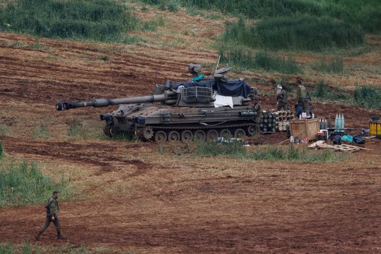afp_69cd689fb280-1775069343-1 Israeli army soldiers stand next to a self-propelled Howitzer artillery gun positioned in the upper Galilee in northern Israel near the border with southern Lebanon on March 28, 2026.