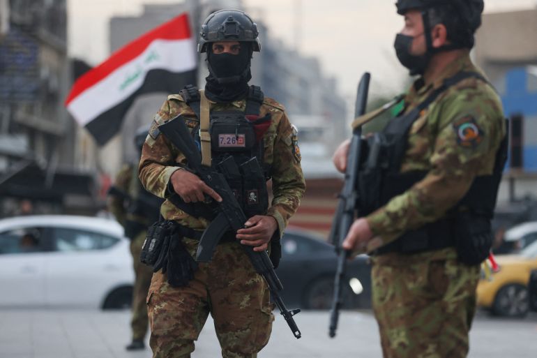 Members of Iraq's Hashed al-Shaabi forces stand guard during a pro-Iran rally in Tahrir Square in Baghdad on April 2, 2026.