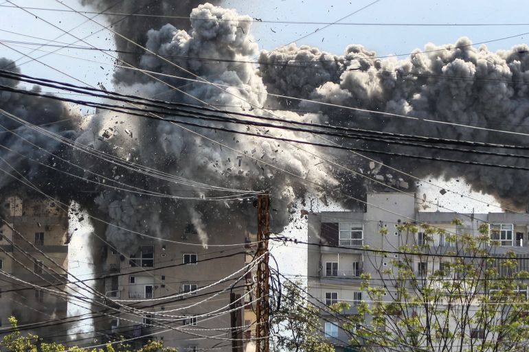 Smoke and debris rise after a building is hit by an Israeli airstrike in the area of Abbasiyeh, on the outskirts of the southern Lebanese city of Tyre, on April 8, 2026.