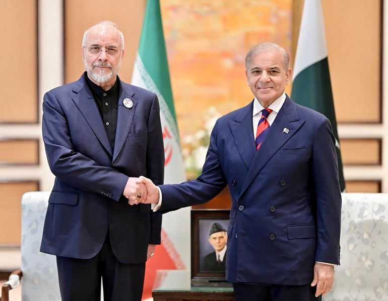 This handout photograph taken on April 11, 2026 and released by Pakistan's Prime Minister Office shows Pakistan's Prime Minister Shehbaz Sharif (R) shaking hands with Iran's parliamentary speaker Mohammad Bagher Ghalibaf during their meeting prior to the US-Iran peace talks in Islamabad.