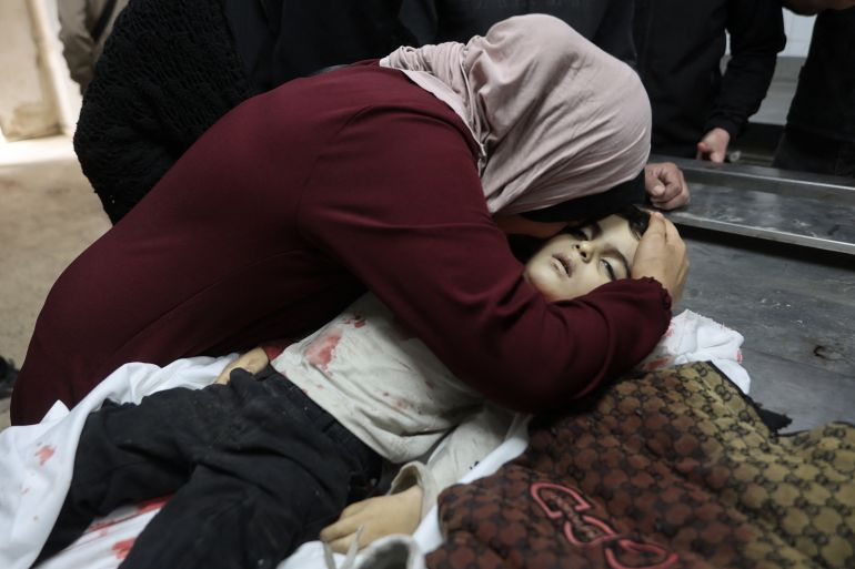 afp_69de99ac80fa-1776196012-1 EDITORS NOTE: Graphic content / TOPSHOT - A relative mourns over the body of three-year-old Yahya al-Malahi, who was killed in an Israeli strike ahead of her funeral in Gaza City on April 14, 2026.