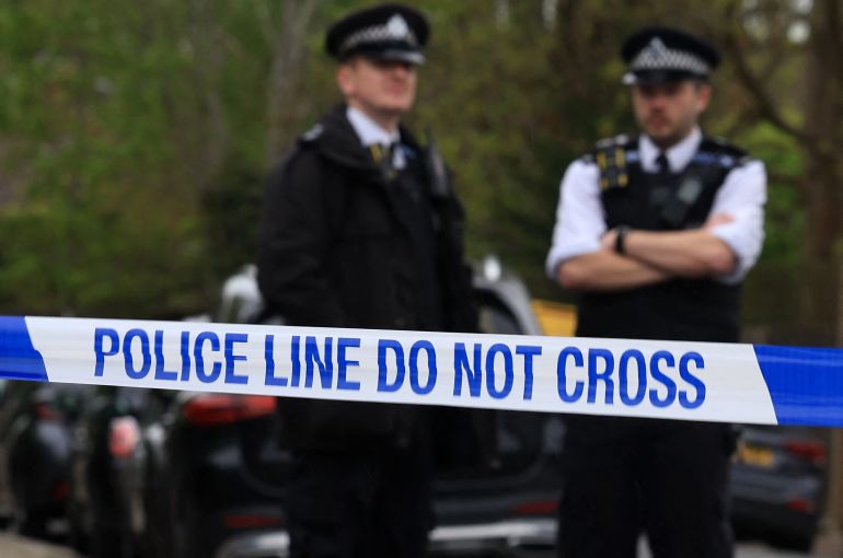 Police officers stand on duty at a cordon near to the Finchley Reform Synagogue, in the North Finchley area of north London, on April 15, 2026, following an attack on the synagogue in the early hours of the morning.