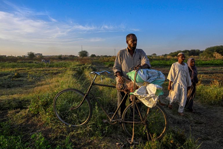 A Sudanese farmer collects some crops from his land on Tuti Island where the White Nile and Blue Nile merge to form the River Nile, off Khartoum on April 17, 2026.
