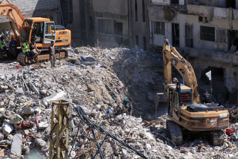 Diggers remove the rubble of buildings destroyed in Israeli strikes as they look for survivors buried underneath in the southern Lebanese coastal city of Tyre on April 21, 2026.