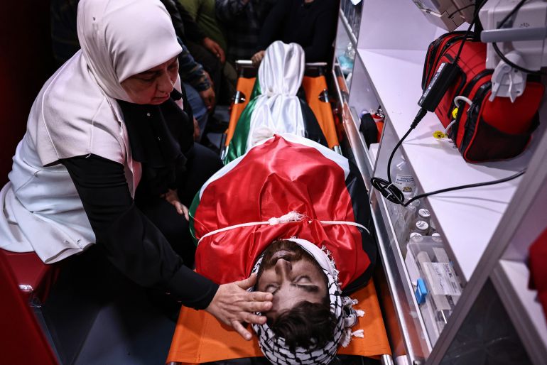 afp_69e9edb350d6-1776938419 EDITORS NOTE: Graphic content / A relative of Awda Atef Awawdeh, a 25-year-old Palestinian man who was killed by alleged settler gunfire in the town of Deir Dibwan in the Israeli-occupied West Bank, mourns over his body at a hospital in Ramallah on April 22, 2026.