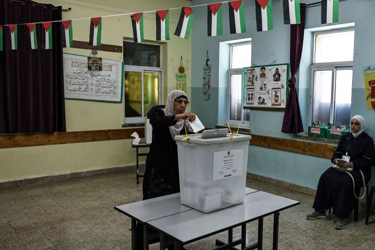 A Palestinian woman casts her ballot at a polling station during municipal elections in city of Al-Bireh, in the Israeli-occupied West Bank on April 25, 2026.