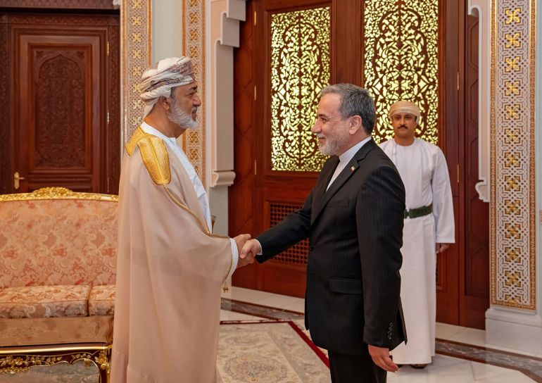 This handout photograph released by the Iran's Foreign Ministry on April 26, 2026 shows Iranian Foreign Minister Abbas Araghchi (R) shaking hands with the Sultan of Oman, Haitham bin Tariq before their meeting in Muscat. (Photo by Iran's Foreign Ministry / AFP) / RESTRICTED TO EDITORIAL USE - MANDATORY CREDIT "AFP PHOTO / IRAN'S FOREIGN MINISTRY" - HANDOUT - NO MARKETING NO ADVERTISING CAMPAIGNS - DISTRIBUTED AS A SERVICE TO CLIENTS