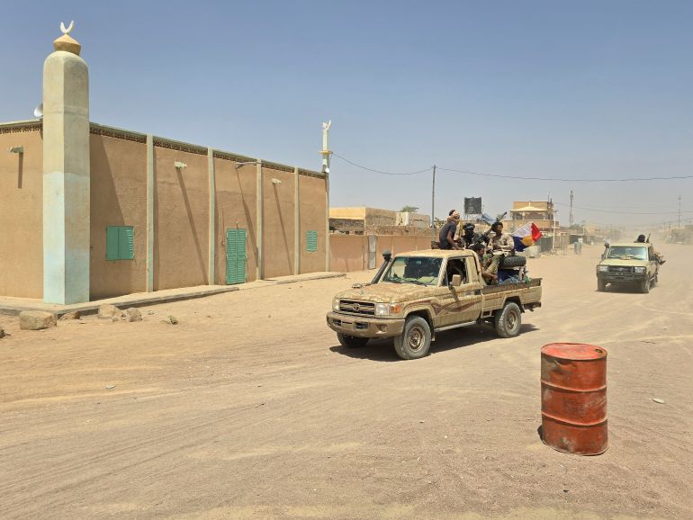 TOPSHOT - Tuareg rebels of the Azawad Liberation Front (FLA) coalition ride on the back of a pickup truck in Kidal, on April 26, 2026.