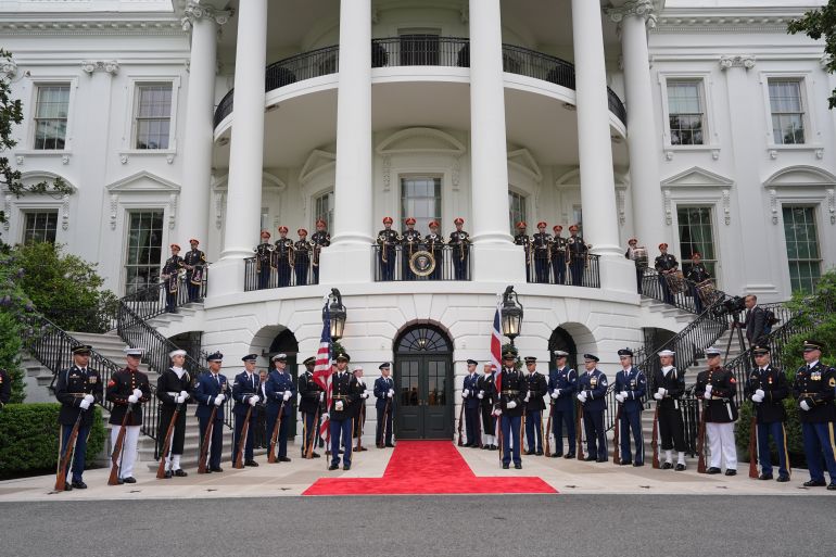 Members of the military honor guard are in place before President Donald Trump and first lady Melania Trump greet Britain's King Charles III and Queen Camilla at the South Portico of the White House for a State Dinner Tuesday, April 28, 2026, in Washington. (AP Photo/Alex Brandon)