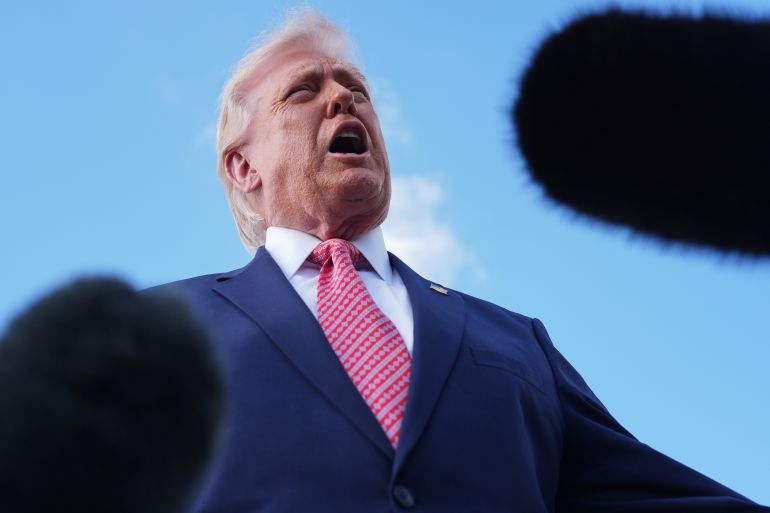 President Donald Trump speaks to reporters after stepping off Air Force One, Friday, March 27, 2026, at Miami International Airport in Miami. (AP Photo/Mark Schiefelbein)