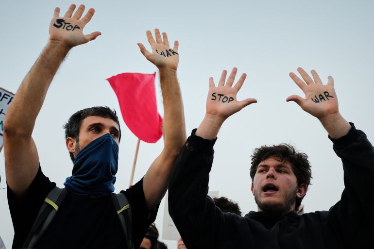 People raise their hands during a protest calling for an end to the war in Tel Aviv, Israel, Saturday, April 4, 2026. (AP Photo/Maya Levin)
