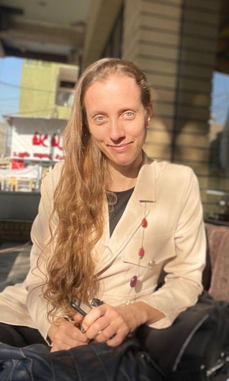 ap_69d5df059cd1c-1775623941 U.S. journalist Shelly Kittleson poses for a cellphone photo in a cafe in Baghdad, Iraq, March 25, 2025. (AP Photo)