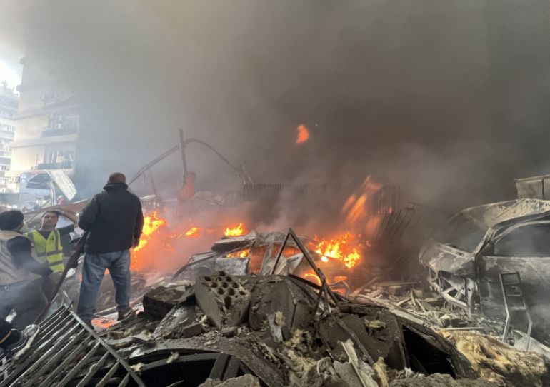 People and rescuers gather at the site of an Israeli airstrike in Beirut, Lebanon, Wednesday, April 8, 2026. (AP Photo/Hussein Malla)