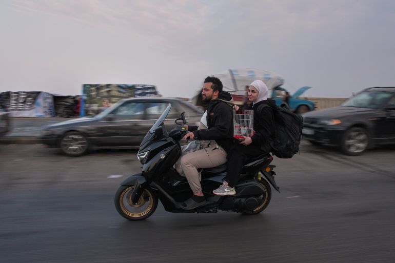 Displaced residents drive a motorcycle back to their villages following a ceasefire between Israel and Hezbollah, in Saida, Lebanon, Friday, April 17, 2026. (AP Photo/Hassan Ammar)