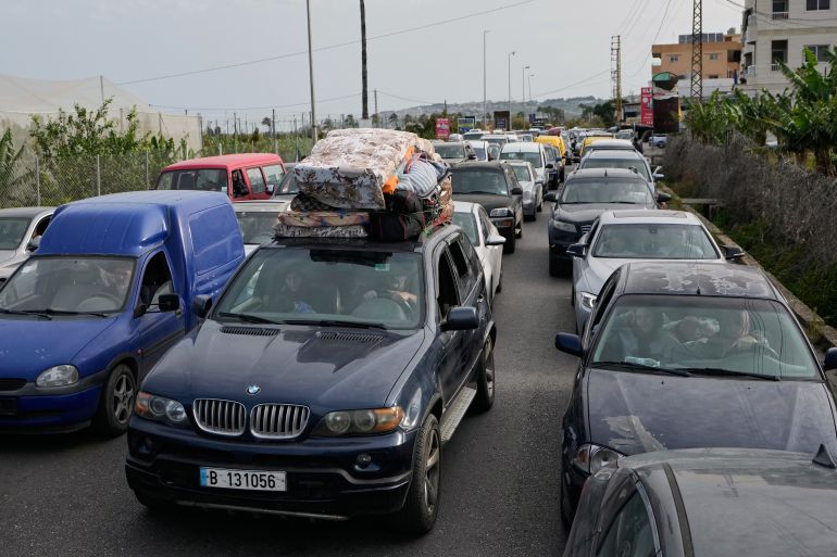 Displaced people in cars queue up to cross a destroyed bridge in Qasmiyeh near Tyre city, south Lebanon, as they return to their villages following a ceasefire between Hezbollah and Israel, Friday, April 17, 2026. (AP Photo/Mohammed Zaatari)