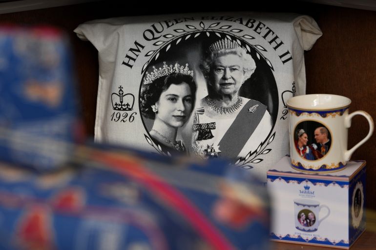 Souvenirs with photos of late Queen Elizabeth II are on display for sale at a souvenirs shop in London, on April 17, 2026. (AP Photo/Kin Cheung)