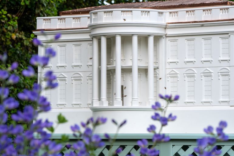 ap_69ec01b473e33-1777074612 Bees fly around a beehive crafted to look like the White House on the South Lawn of the White House, Friday, April 24, 2026, in Washington. (AP Photo/Alex Brandon)