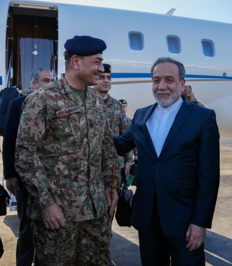 In this photo released by the Iranian Foreign Ministry, Pakistan's Army Chief Field Marshal Gen. Asim Munir, left, is welcomed by Iranian Foreign Minister Abbas Araghchi upon his arrival in Tehran, Wednesday, April 15, 2026. (Iranian Foreign Ministry via AP)