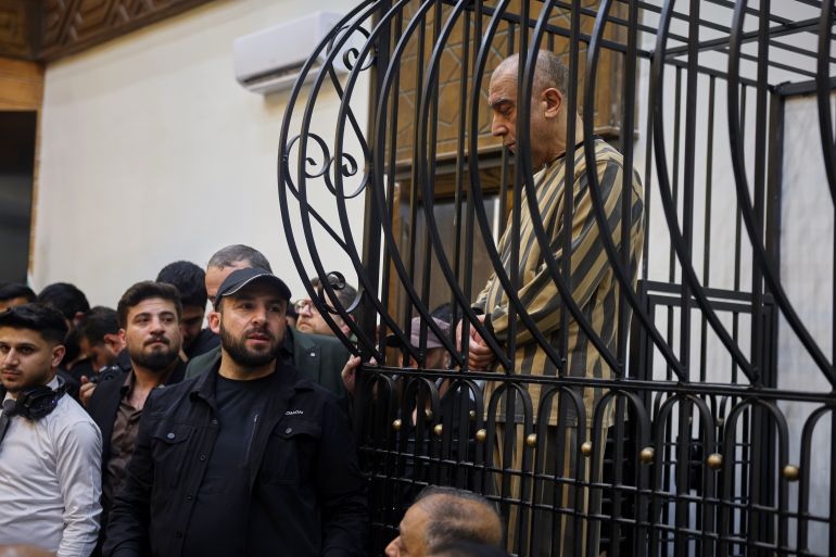 Atef Najib, former head of the Political Security Branch in the Daraa area during Bashar Assad's rule, sits in the defendants' cage during a trial session at the Palace of Justice in Damascus, Syria, Sunday, April 26, 2026. (AP Photo/Ghaith Alsayed)