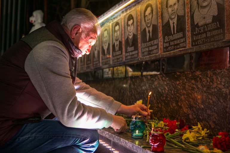 ap_69ee91f0899d2-1777242608 A man lights a candle at a memorial dedicated to firefighters and workers who died after the 1986 Chornobyl (Chernobyl) nuclear disaster, ahead of its 40th anniversary in Slavutych, Ukraine, Saturday, April 25, 2026. Chornobyl is the Ukrainian name for the city. (AP Photo/Dan Bashakov)