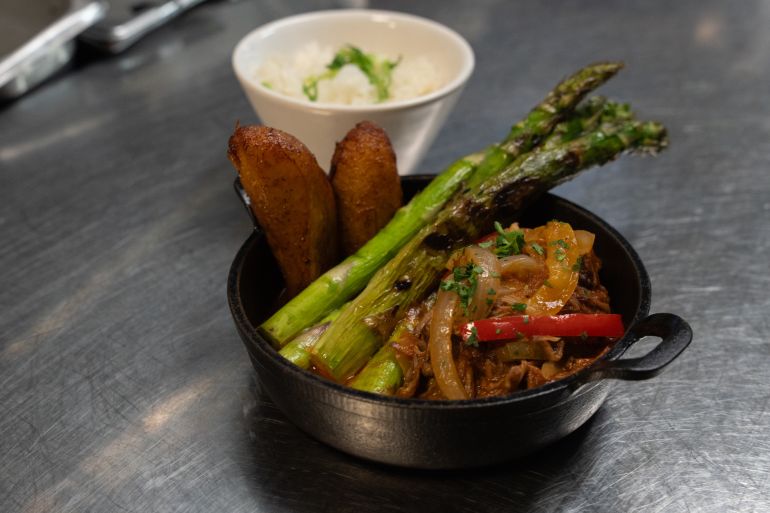 A ropa vieja dish from Cuba Libre Restaurant and Rum Bar's GLP-Wonderful menu is prepared for serving at the restaurant in Philadelphia, on Friday, March 6, 2026. (AP Photo/Mingson Lau)