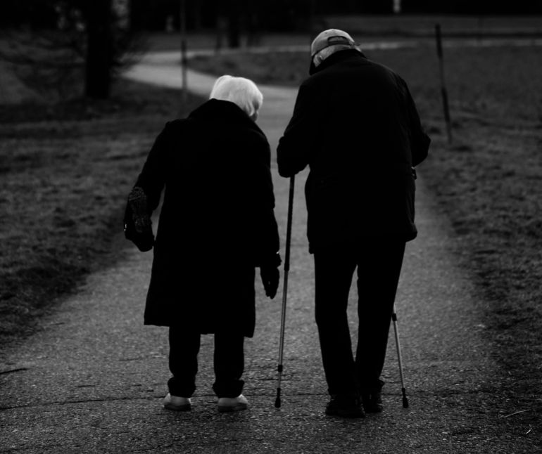 d983d8a8d8a7d8b1-d8a7d984d8b3d9861-1776182881 A vertical grayscale shot of old spouses walking in the park - aging concept