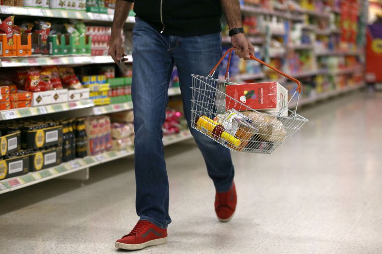 FILE PHOTO: A shopper carries a basket in a supermarket in London, Britain April 11, 2017. REUTERS/Neil Hall/File Photo