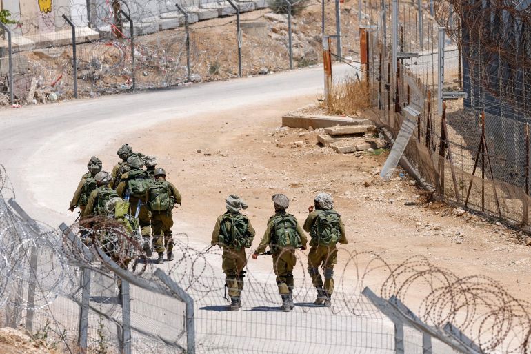 Israeli troops patrol the border fence with Syria near the Druze village of Majdal Shams in the Israel-annexed Golan Heights on July 23, 2025. Israeli troops on July 16 sought to control crowds and prevent Druze from crossing the security fence with Syria, with soldiers in the occupied Golan Heights firing teargas to keep order along the heavily fortified frontier after dozens of people tried to cross over amid deadly violence in Syria's southern Druze heartland that prompted Damascus to send in government forces. (Photo by Jalaa MAREY / AFP)