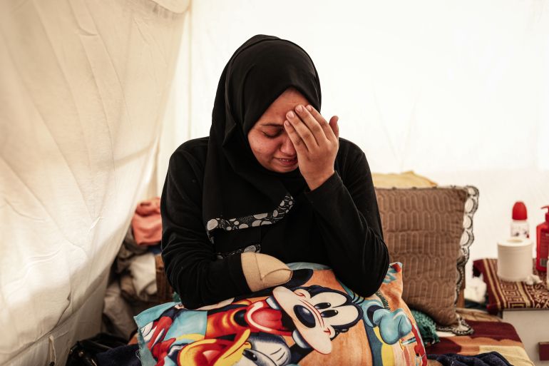 GAZA CITY, GAZA - JANUARY 24: Samah Afane, a 37-year-old pregnant woman heavily injured in an attack near her home in the al-Shati Refugee Camp, lost her right hand and suffered severe damage to her foot in Gaza City, Gaza on January 24, 2026. Six months pregnant at the time of the injury, Afane gave birth to her son Muhammed 20 days ago despite her physical disabilities.Unable to breastfeed or independently care for her newborn due to her injuries, Afane receives support from her husband Ihab Afane as the family struggles to survive under difficult conditions. (Photo by Moiz Salhi/Anadolu via Getty Images)