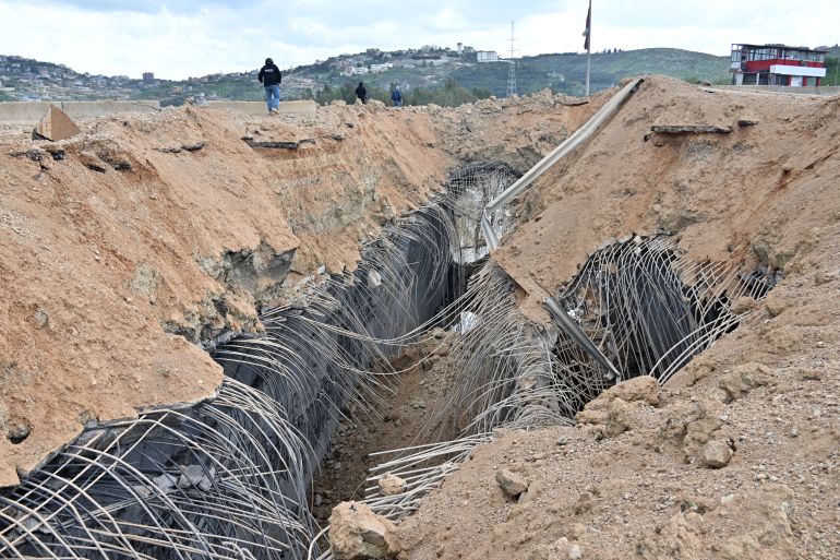 epa12843800 Damage at the site of an Israeli strike targeting the Qasmiya Bridge near Tyre, southern Lebanon, 23 March 2026. According to the Lebanese National News Agency (NNA), the Israeli military carried out airstrikes on the Qasmiya Bridge, a key crossing point over the Litani River connecting southern Lebanon to the north. EPA/STRINGER