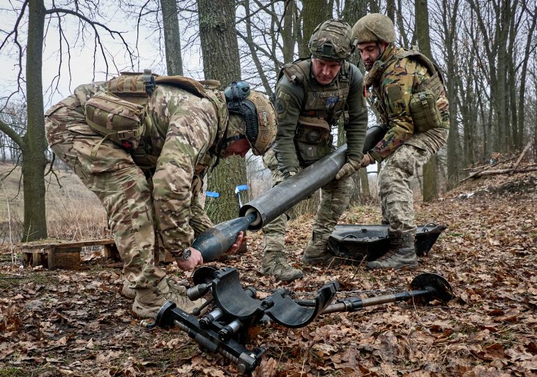 epa_69c6a63e5aab-1774626366 epa12854036 Ukrainian servicemen from the 13th 'Khartiya' Brigade of the National Guard of Ukraine take part in training to safely extract unexploded mortar rounds from a launch tube as they prepare for deployment to combat positions, at an undisclosed location in the Kharkiv region, northeastern Ukraine, 27 March 2026, amid the Russian invasion. EPA/SERGEY KOZLOV