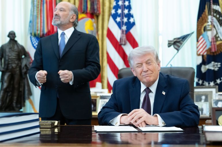 epa_69cd43a8041f-1775059880 epa12863112 US President Donald J Trump (R) gestures as US Secretary of Commerce Howard Lutnick (L) speaks during an executive order signing event in the Oval Office of the White House in Washington, DC, USA, 31 March 2026. The order directs the federal government, through the US Postal Service, to provide states with voter eligibility data. EPA/AARON SCHWARTZ / POOL