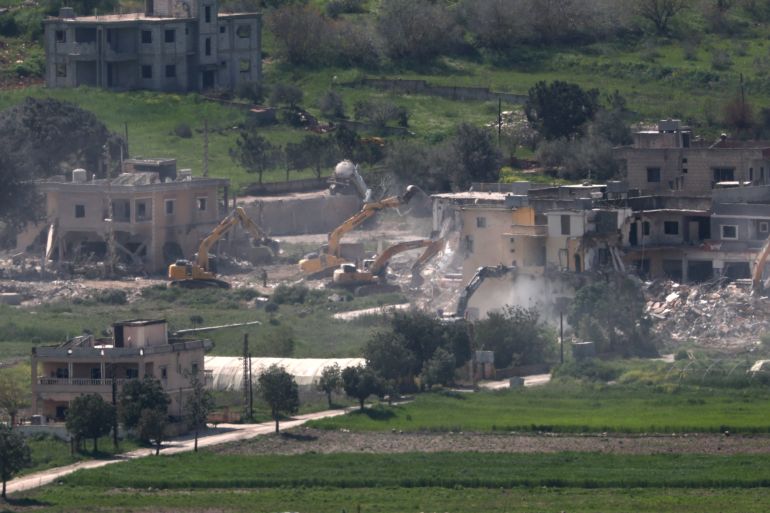 epa12887477 Israeli army excavators demolish buildings in the southern Lebanese village of Mais al-Jabal, as seen from the Israeli side of the border, 13 April 2026. The Israeli military stated it is conducting operations in southern Lebanon targeting Hezbollah infrastructure and personnel. EPA/ATEF SAFADI