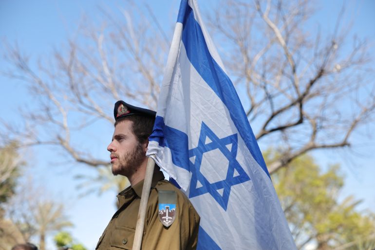 epa_69f08330867b-1777369904 epa12861773 An Israeli soldier holds the national flag during the funeral of Staff Sergeant Maxsim Entis in Bat Yam, Israel, 31 March 2026. Entis was one of four Israeli soldiers killed the previous day during combat with Hezbollah operatives in southern Lebanon, the Israeli military said. EPA/ABIR SULTAN