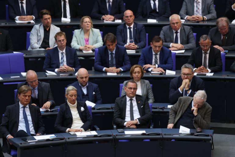 getty_684a93a3e6-1749717923 BERLIN, GERMANY - MAY 08: Bundestag members of the far-right Alternative for Germany (AfD) listen as German President Frank-Walter Steinmeier speaks during a commemoration at the Bundestag on the 80th anniversary of the end of World War II, also known as VE Day, on May 08, 2025 in Berlin, Germany. Events, both unofficial and official, are taking place across the city today to mark the 1945 capitulation of Nazi Germany. The Soviet Red Army took Berlin in April of 1945 after a succession of among the costliest battles of the war. (Photo by Sean Gallup/Getty Images)