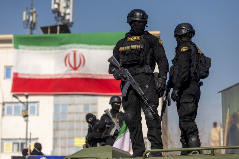getty_6965a85b80-1768269915 TEHRAN, IRAN - JANUARY 12: Security forces are seen during a pro-government rally on January 12, 2026 in Tehran, Iran. Tens of thousands of demonstrators gathered in Tehran's Enqelab Square on Monday, as Mohammad Bagher Ghalibaf, speaker of the Iranian parliament, made a speech denouncing western intervention in Iran, following ongoing anti-government protests. In recent days, US President Donald Trump has repeatedly threatened military action if Iranian security forces kill protesters. (Photo by Stringer/Getty Images)