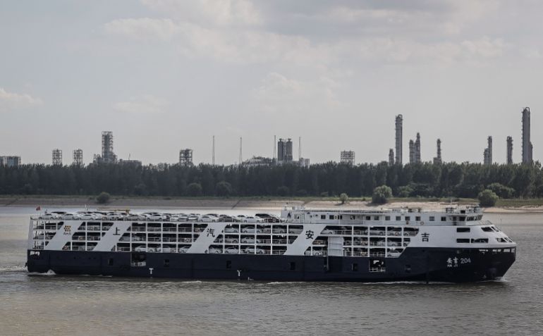 WUHAN, CHINA - JUNE 26: A cargo ship full of cars passes Yangluo container port on the Yangtze River on June 26 ,2018 in Wuhan,Hubei province , China. Wuhan New Port comprises four ports in Hubei Province - Wuhan, Ezhou, Huanggang and Xianning. Yangluo Container Port is a major harbor in Wuhan, the capital city of central China's Hubei Province. It handles large amounts of containers and there are direct vessels from Wuhan New Port to Shanghai and onwards to the world every day. (Photo by Wang He/Getty Images)