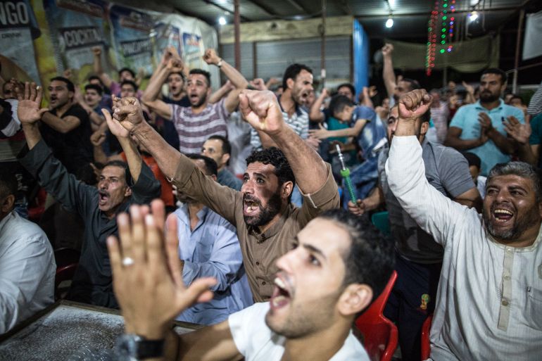 GHARBIA, EGYPT - JUNE 01: Egyptians celebrate Liverpool's goal while watching the UEFA Champions League Final football match between Tottenham Hotspur FC and Liverpool FC, at a cafe where Liverpool's Egyptian footballer Mohamed Salah was born and raised in the village of Nagrig, on June 01, 2019 in Gharbia, Egypt. (Photo by Mahmoud Khaled/Getty Images)