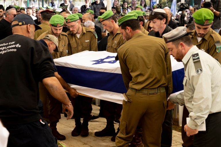 BAT YAM, ISRAEL - MARCH 31: Israeli soldiers carry the coffin covered with an Israeli flag during the funeral for Israeli soldier, Staff Sgt. Maxsim Entis, who was killed in a battle in Southern Lebanon a day ago, among three more Israeli soldiers on March 31, 2026 in Holon Cemetery, Bat Yam, Israel. Israel and Hezbollah have continued exchanging hostilities across Israel's northern border with Lebanon, after the Iran-backed militant group began launching missiles at Israel on March 2, in what it said was retaliation for the joint U.S.-Israeli war on Iran. (Photo by Amir Levy/Getty Images)