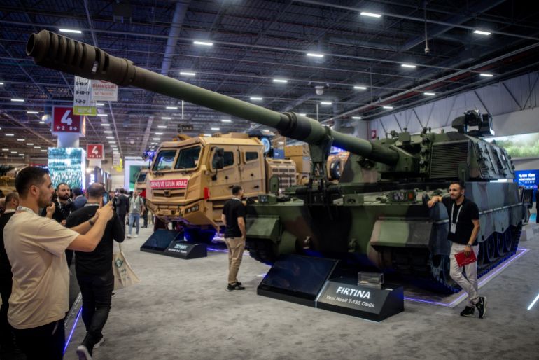 ISTANBUL, TURKEY - JULY 24: People walk past a military land vehicles display at Turkey's 17th International Defense Industry Fair (IDEF) In Istanbul on July 24, 2025 in Istanbul, Turkey. Turkish and foreign companies showcased defense technology and weaponry at the fair running from July 22-27. (Photo by Chris McGrath/Getty Images)
