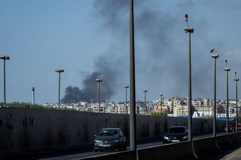 BEIRUT, LEBANON - APRIL 05: Cars drive on the highway in front of a plume of smoke rising from the Dahieh neighbourhood after an Israeli airstrike on April 05, 2026 in Beirut, Lebanon. Israel has continued its aerial and ground assault in Lebanon after Hezbollah, the Iran-backed militant group in Lebanon, launched missiles at Israel in what it said was retaliation for the joint U.S.-Israeli war on Iran. (Photo by Chris McGrath/Getty Images)