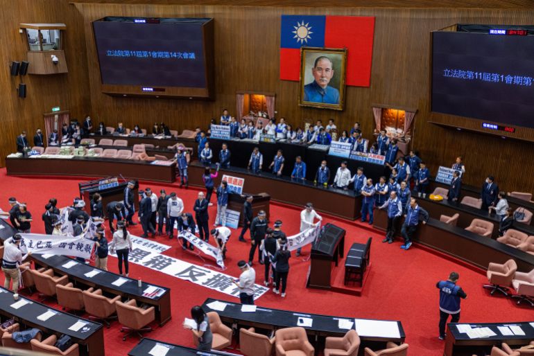 getty_69d4a57ba7-1775543675 TAIPEI, TAIWAN - MAY 21: The legislators of Democratic Progressive Party (DPP) protest against the opposition Kuomintang (KMT), and Taiwan People's Party (TPP) over the parliament reforms on May 21, 2024 in Taipei, Taiwan. Taiwan parliament erupted in arguments again on Tuesday, follow the chaotic scenes that unfolded on Friday, where legislators punched, kicked, pushed and shoved each other during a heated debate over proposed reforms. The opposition wants to give parliament greater scrutiny powers over the government, the most controversial is a "contempt of parliament" offence, effectively criminalising officials unwilling to cooperate with legislative investigations. (Photo by Annabelle Chih/Getty Images)