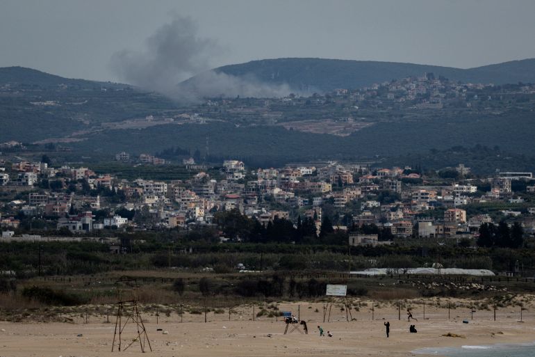TYRE, LEBANON - APRIL 14: People visit the beach as smoke rises on the hillside, from an Israeli strike on April 14, 2026 in Tyre, Lebanon. Israel has stepped-up its attacks on Lebanon following President Donald Trump's announcement of a two-week ceasefire agreement between the US and Iran, conditional on shipping being allowed to resume through the Strait of Hormuz. Israel says it will observe the ceasefire with Iran but insists Lebanon was not included in the deal, and has since launched the "largest coordinated strike" on Hezbollah targets since the cross-border war began on March 2. Iran and Pakistan - which has been coordinating peace talks - have said that the ceasefire would include Lebanon, while the US has yet to weigh-in. (Photo by Chris McGrath/Getty Images)