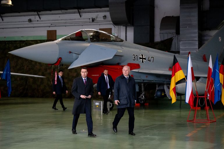 MALBORK, POLAND - DECEMBER 10: Nils Schmid, Parliamentary State Secretary at the German Ministry of Defence and Deputy Minister of National Defense of Poland Pawel Zalewski seen entering the press conference, visiting the Bundeswehr deployment at the Polish air force base on December 10, 2025 in Malbork, Poland. Germany has deployed five Luftwaffe Eurofighter combat jets and 150 Bundeswehr personnel to Malbork as part of a NATO response to continuing violations of Polish airspace by Russian military planes and drones. (Photo by Mateusz Slodkowski/Getty Images)