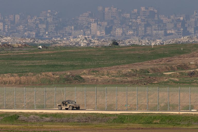 SOUTHERN ISRAEL, ISRAEL - JANUARY 16: An army vehicle moves a long the border with the northern Gaza Strip as seen from a position on the Israeli side of the border on January 16, 2026 in Southern Israel, Israel. On Wednesday, US envoy Steve Witkoff announced the start of the 20-point Gaza ceasefire plan's second phase, with a focus on reconstruction and demilitarization, and a "transitional technocratic Palestinian administration in Gaza." Israel has continued to call for the further demilitarization of Hamas and the return of the remains of the last hostage remaining in Gaza, the 24-year-old police officer Ran Gvili. (Photo by Amir Levy/Getty Images)