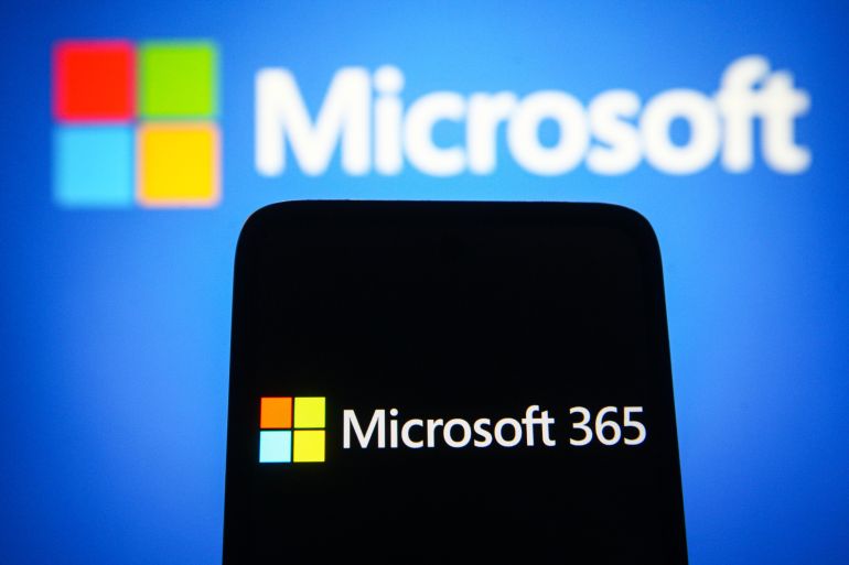 gettyimages-1235307397-1693729108 UKRAINE - 2021/09/16: In this photo illustration a Microsoft 365 logo is seen on a smartphone screen with a Microsoft logo in the background. (Photo Illustration by Pavlo Gonchar/SOPA Images/LightRocket via Getty Images)