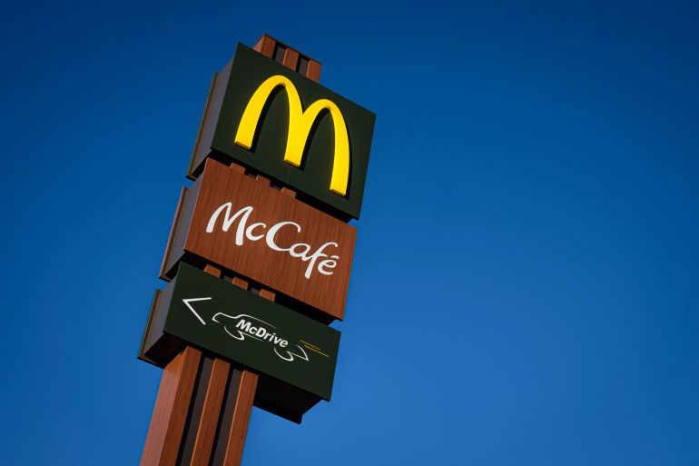 ORBASSANO, TURIN, ITALY - 2023/09/24: McDonald's, McCafe and McDrive logos are seen on a sign above a fast food restaurant in Orbassano near Turin. (Photo by Nicolò Campo/LightRocket via Getty Images)