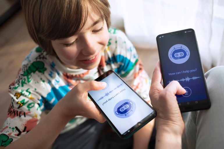 gettyimages-2203265972-1754242750 Happy friends comparing two different chatbots. Using system AI Chatbot on mobile application. Chatbot conversation, Artificial Intelligence technology. Virtual assistant on internet. Competitor.